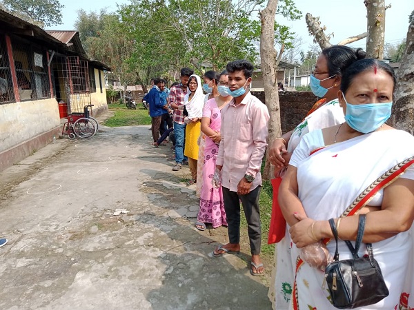 असम में मतदान के लिए लाइन में लगे मतदाता
